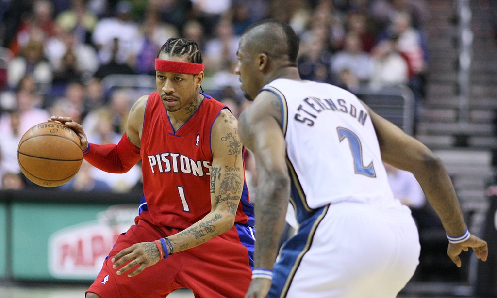 Iverson dribbles past a player for the Pistons