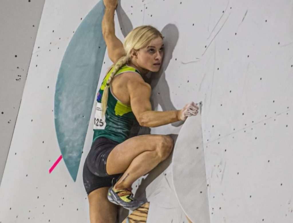 Woman climber climbs indoor gym Anna Davey