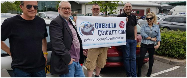 five-members-of-team-guerilla-holding-a-poster